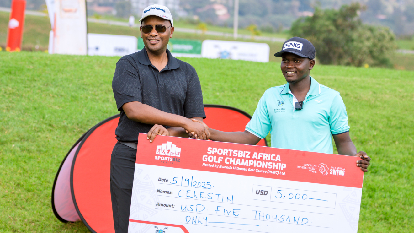 Rwanda Golf Union Chairman, Amb. Bill Kayonga presents the winner's prize to Celestin Nsanzuwera, winner of the SportsBiz Africa Golf Championship in Kigali. PHOTO/COURTESY